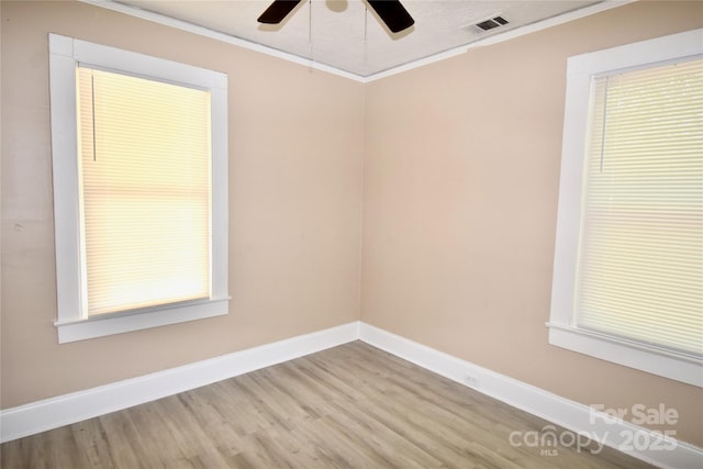 2017 Ashley Rd, Charlotte, NC 28208 - spare room with crown molding, wood finished floors, and a ceiling fan