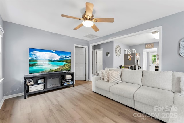 310 S Jacob St, Cherryville, NC 28021 - living room with a ceiling fan, light wood-type flooring, and baseboards