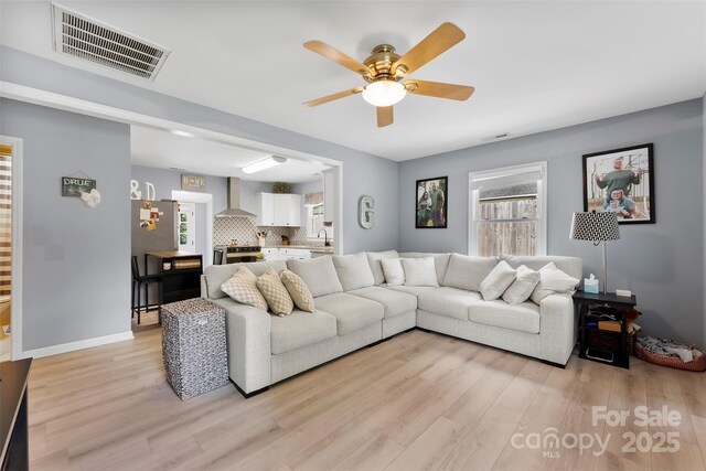 310 S Jacob St, Cherryville, NC 28021 - living area with healthy amount of natural light, light wood-type flooring, a ceiling fan, and baseboards