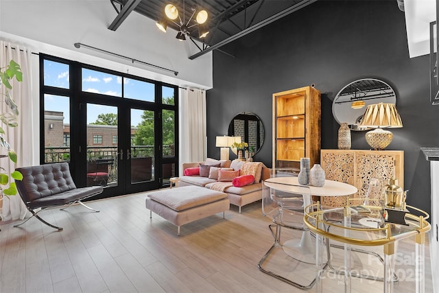 720 Governor Morrison St Unit 219, Charlotte, NC 28211 - living room with a towering ceiling, french doors, a chandelier, and wood finished floors