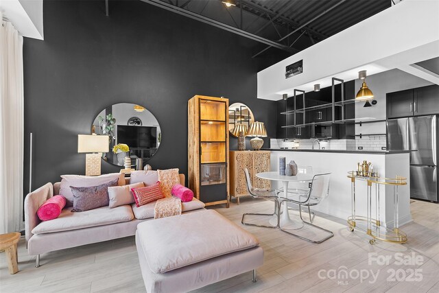720 Governor Morrison St Unit 219, Charlotte, NC 28211 - living area featuring light wood-style floors and a towering ceiling