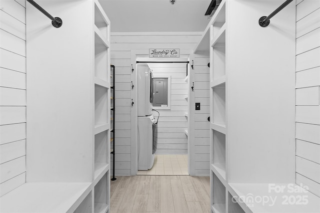 720 Governor Morrison St Unit 219, Charlotte, NC 28211 - walk in closet featuring stacked washer / drying machine and light wood-style flooring