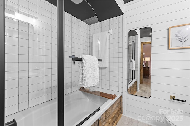 720 Governor Morrison St Unit 219, Charlotte, NC 28211 - bathroom with shower / bathtub combination, wood walls, and wood finished floors