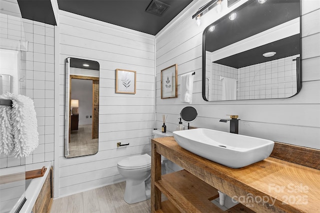 720 Governor Morrison St Unit 219, Charlotte, NC 28211 - bathroom with wooden walls, wood finished floors, and vanity