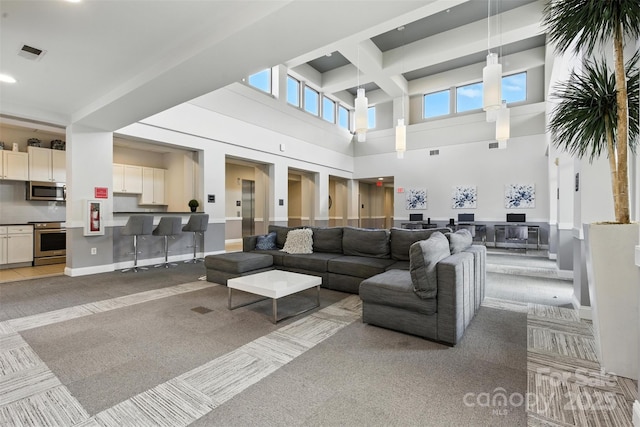 720 Governor Morrison St Unit 219, Charlotte, NC 28211 - living room with light colored carpet, a high ceiling, healthy amount of natural light, and recessed lighting