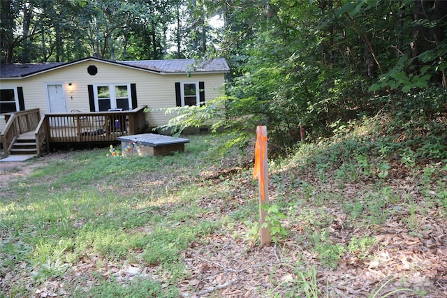 226 Lake Sylvia Rd, Lincolnton, NC 28092 - rear view of house with a deck and a metal roof