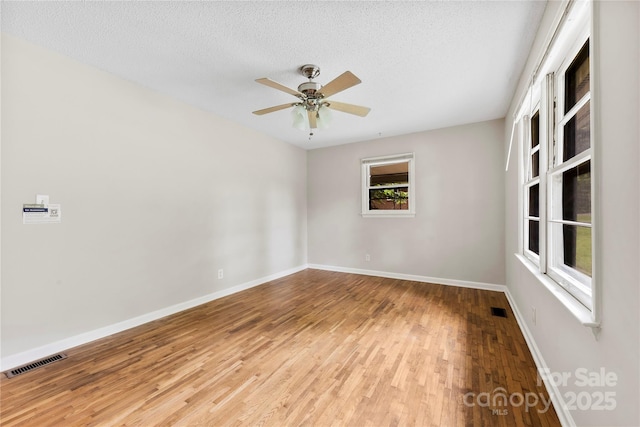 1156 Westover Cir, Rock Hill, SC 29732 - spare room featuring wood finished floors, a textured ceiling, ceiling fan, and baseboards