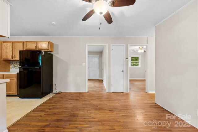 1156 Westover Cir, Rock Hill, SC 29732 - kitchen featuring freestanding refrigerator, ceiling fan, crown molding, light wood finished floors, and light countertops
