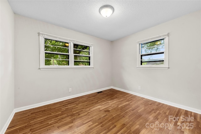 1156 Westover Cir, Rock Hill, SC 29732 - spare room featuring wood finished floors, baseboards, and a textured ceiling