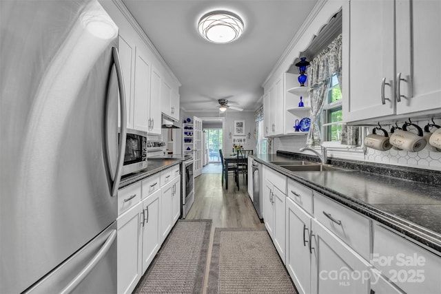 162 Candle St, West Jefferson, NC 28694 - kitchen with appliances with stainless steel finishes, a sink, white cabinetry, under cabinet range hood, and healthy amount of natural light