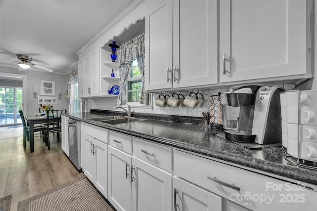 162 Candle St, West Jefferson, NC 28694 - kitchen with a sink, stainless steel dishwasher, a ceiling fan, white cabinetry, and backsplash
