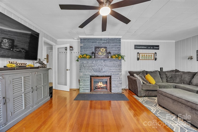 162 Candle St, West Jefferson, NC 28694 - living room featuring ornamental molding, a ceiling fan, wood finished floors, and a stone fireplace