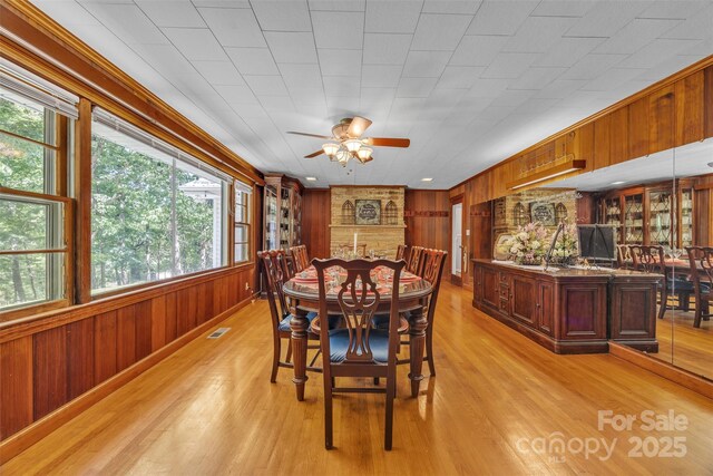 162 Candle St, West Jefferson, NC 28694 - dining room featuring ceiling fan, wooden walls, and light wood finished floors
