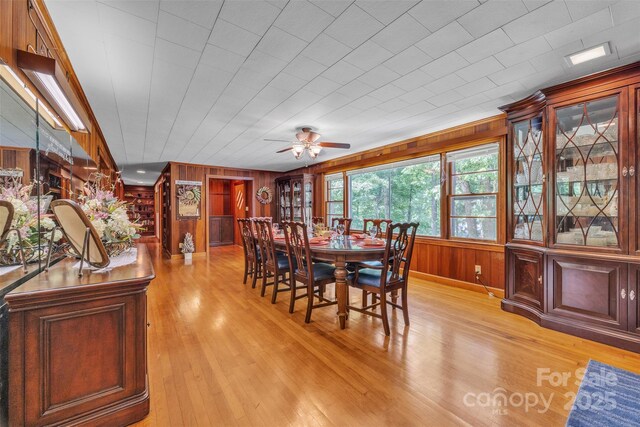 162 Candle St, West Jefferson, NC 28694 - dining space featuring wood walls, light wood-style floors, and ceiling fan