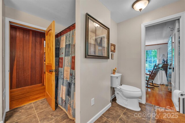 162 Candle St, West Jefferson, NC 28694 - bathroom with tile patterned floors, toilet, curtained shower, and baseboards