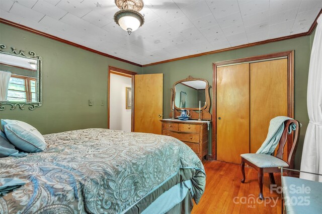 162 Candle St, West Jefferson, NC 28694 - bedroom with wood finished floors, a closet, and ornamental molding