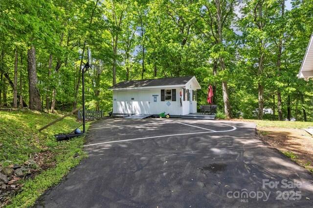 162 Candle St, West Jefferson, NC 28694 - view of front of property with an outdoor structure, view of wooded area, and uncovered parking