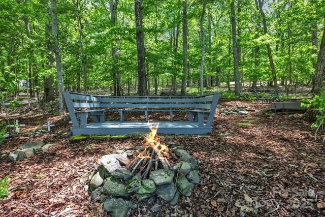 162 Candle St, West Jefferson, NC 28694 - exterior view of a fire pit and a heavily wooded area