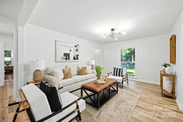 6127 Eagle Peak Dr, Charlotte, NC 28214 - living area featuring light wood-style flooring and a chandelier