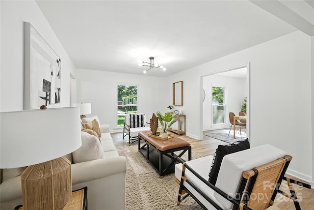 6127 Eagle Peak Dr, Charlotte, NC 28214 - living area with plenty of natural light, a chandelier, and light wood-style flooring
