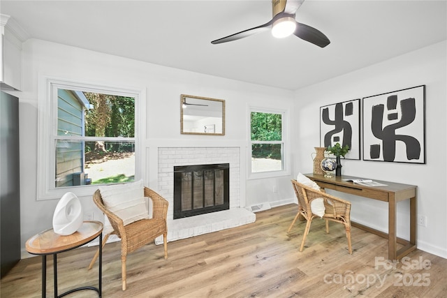 6127 Eagle Peak Dr, Charlotte, NC 28214 - home office with light wood-type flooring, a fireplace, healthy amount of natural light, and ceiling fan