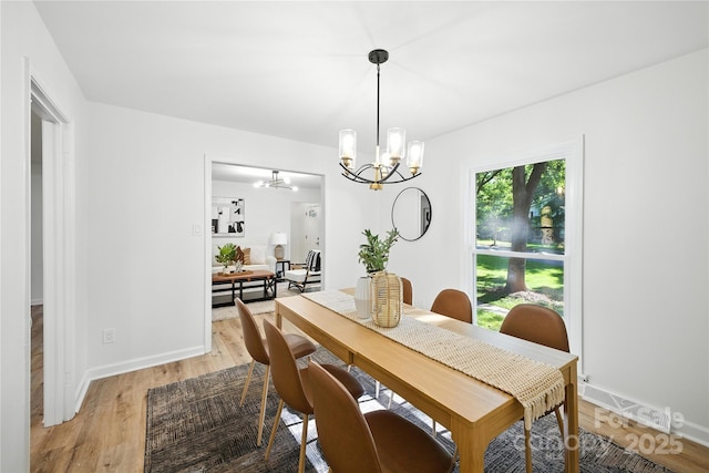 6127 Eagle Peak Dr, Charlotte, NC 28214 - dining space with a chandelier and light wood-type flooring