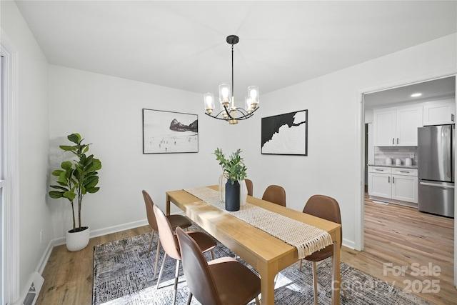 6127 Eagle Peak Dr, Charlotte, NC 28214 - dining space with light wood-style flooring and a chandelier