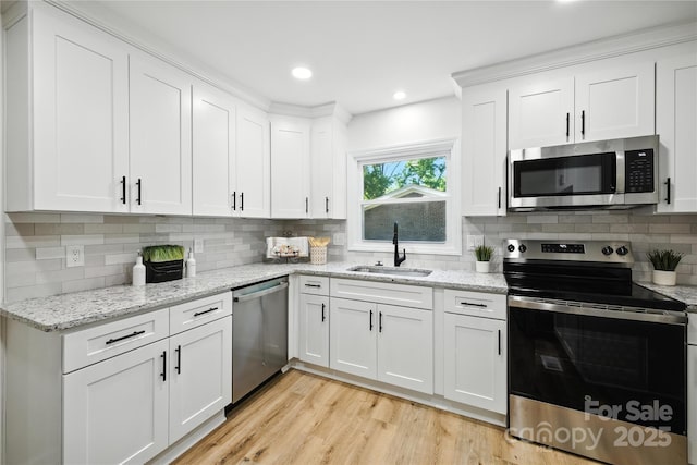 6127 Eagle Peak Dr, Charlotte, NC 28214 - kitchen featuring stainless steel appliances, white cabinets, backsplash, light wood finished floors, and light stone countertops
