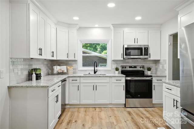 6127 Eagle Peak Dr, Charlotte, NC 28214 - kitchen featuring appliances with stainless steel finishes, white cabinetry, tasteful backsplash, and recessed lighting