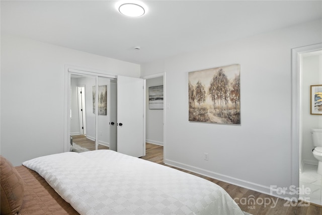 6127 Eagle Peak Dr, Charlotte, NC 28214 - bedroom with a closet, wood finished floors, and connected bathroom