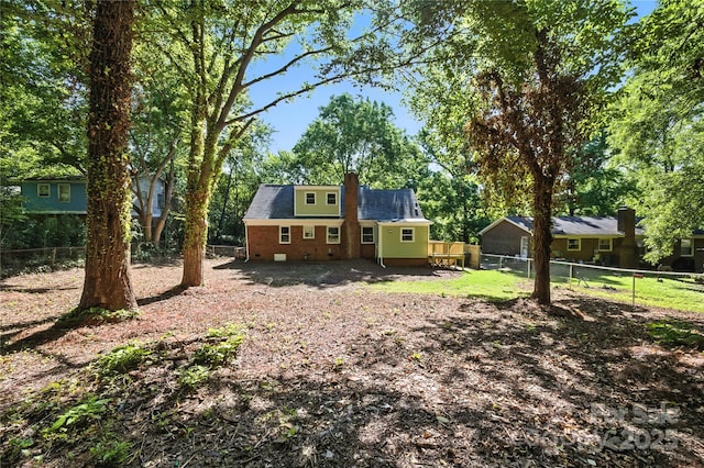 6127 Eagle Peak Dr, Charlotte, NC 28214 - back of house featuring a chimney, a fenced backyard, brick siding, crawl space, and view of scattered trees