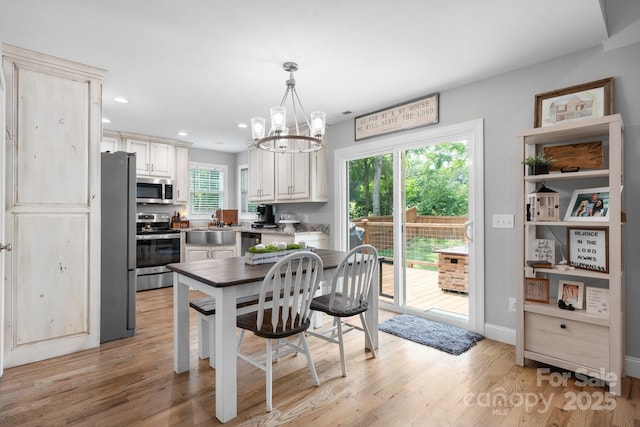140 Maplewood Ct, Hudson, NC 28638 - kitchen with appliances with stainless steel finishes, a chandelier, light wood-type flooring, recessed lighting, and hanging light fixtures