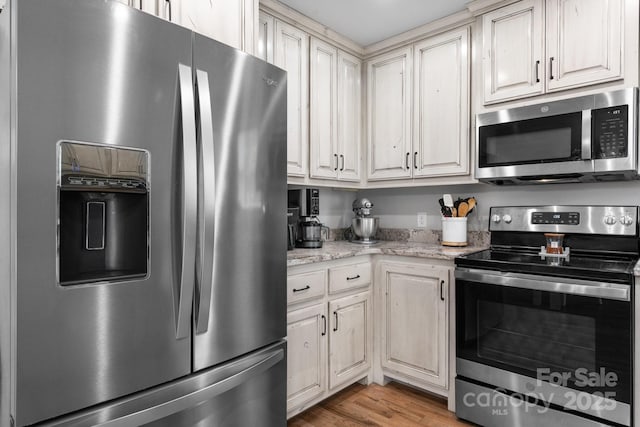 140 Maplewood Ct, Hudson, NC 28638 - kitchen featuring appliances with stainless steel finishes, light wood finished floors, and light stone counters