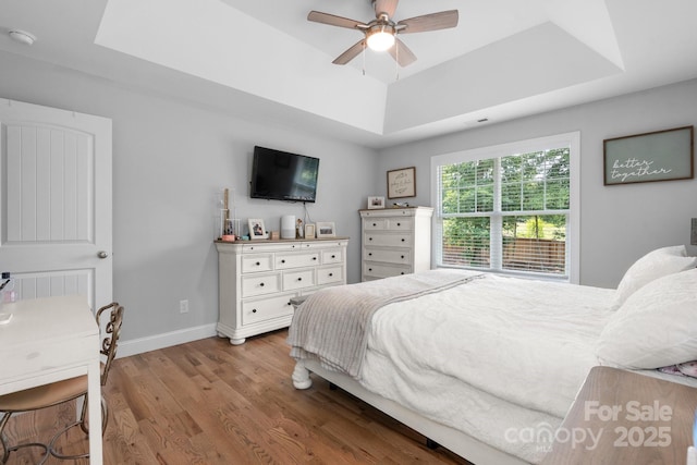140 Maplewood Ct, Hudson, NC 28638 - bedroom featuring a raised ceiling, wood finished floors, baseboards, and ceiling fan