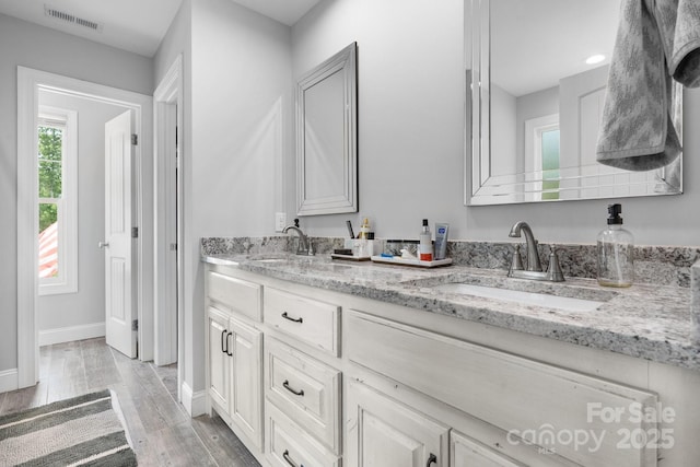 140 Maplewood Ct, Hudson, NC 28638 - bathroom featuring double vanity, baseboards, and wood finished floors