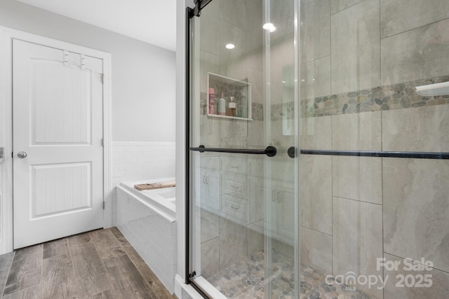 140 Maplewood Ct, Hudson, NC 28638 - bathroom with a bath, a stall shower, and wood finished floors