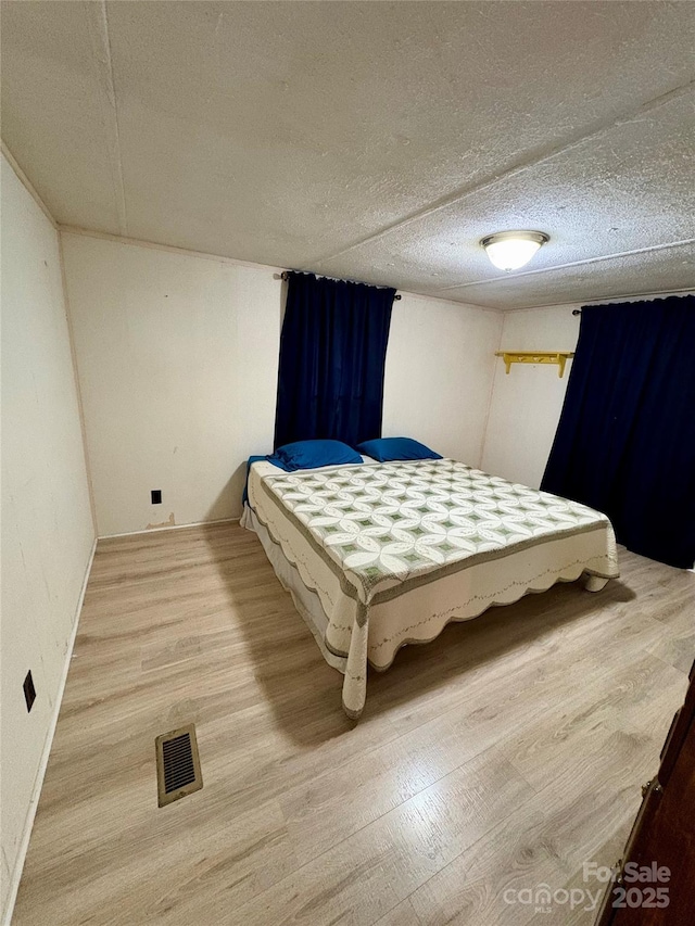 5022 Wrenn Dr, Denver, NC 28037 - bedroom with wood finished floors, a textured ceiling, and baseboards