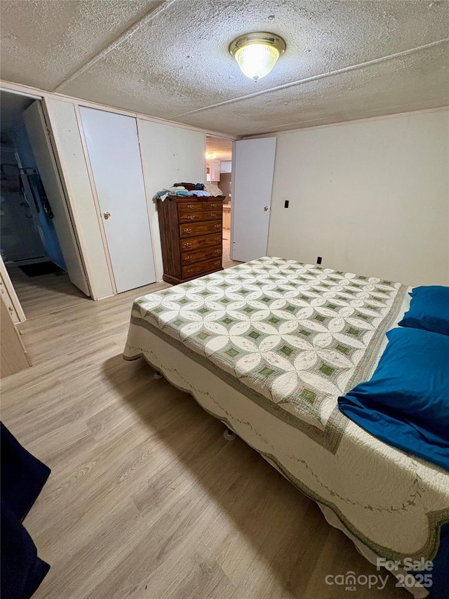 5022 Wrenn Dr, Denver, NC 28037 - bedroom with light wood-style floors and a textured ceiling