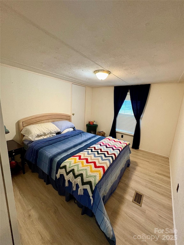 5022 Wrenn Dr, Denver, NC 28037 - bedroom with wood finished floors and a textured ceiling