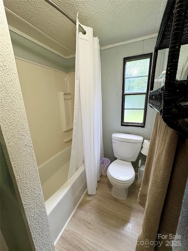 5022 Wrenn Dr, Denver, NC 28037 - bathroom featuring wood finished floors, toilet, a textured ceiling, and shower / bathtub combination with curtain