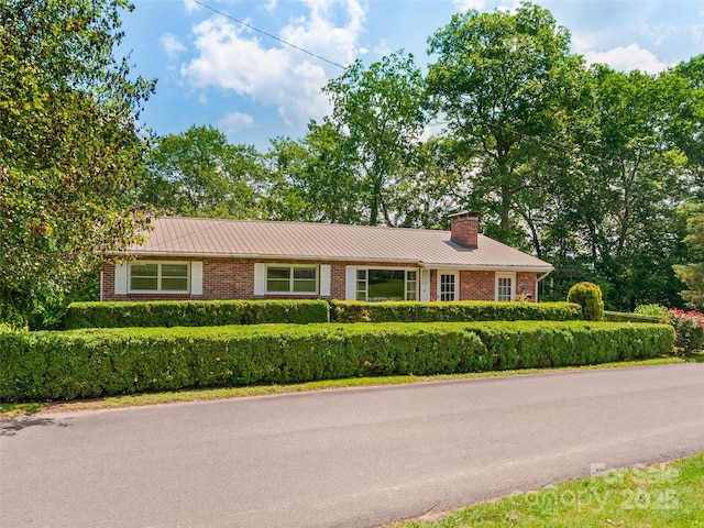 167 Panorama Dr, Franklin, NC 28734 - single story home with brick siding, a chimney, metal roof, and a standing seam roof