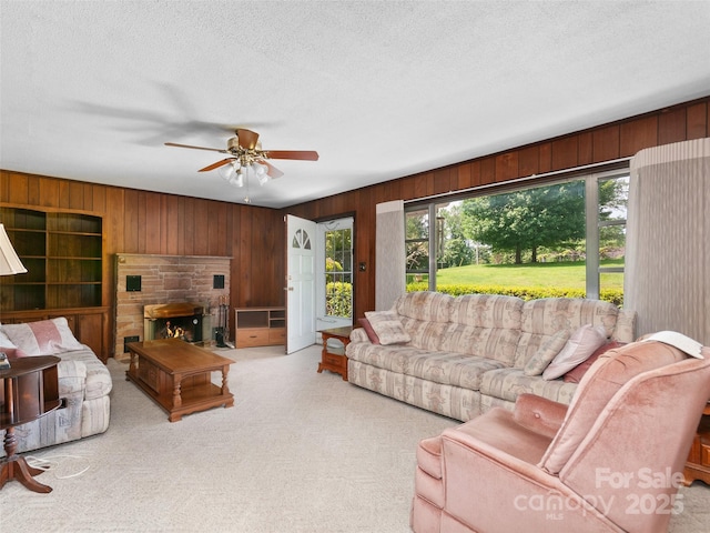 167 Panorama Dr, Franklin, NC 28734 - carpeted living room featuring wood walls, ceiling fan, and a textured ceiling
