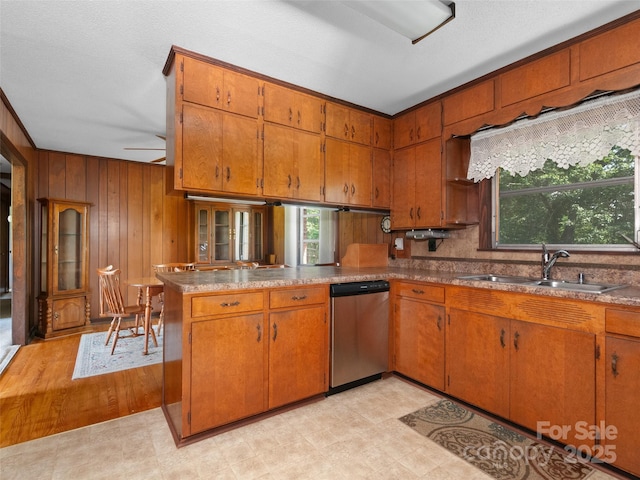 167 Panorama Dr, Franklin, NC 28734 - kitchen with dishwasher, a sink, brown cabinetry, wooden walls, and a peninsula