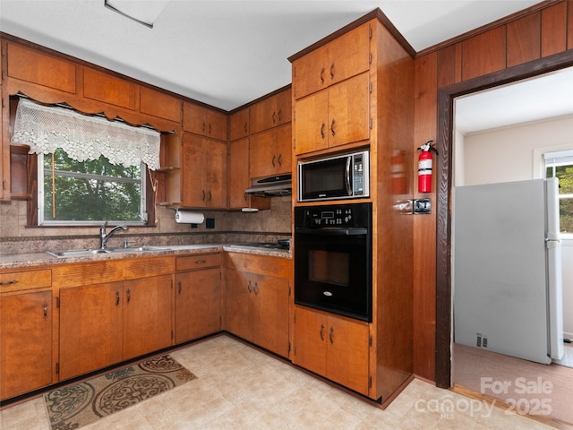 167 Panorama Dr, Franklin, NC 28734 - kitchen featuring black appliances, a sink, under cabinet range hood, and brown cabinets