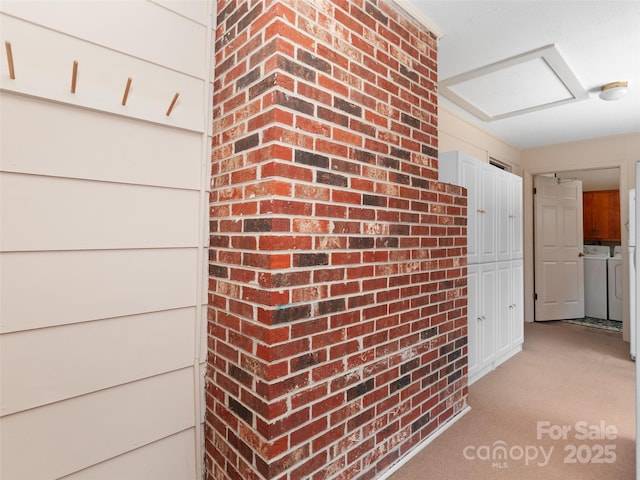 167 Panorama Dr, Franklin, NC 28734 - hallway featuring washing machine and clothes dryer, light colored carpet, and brick wall