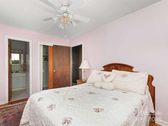 167 Panorama Dr, Franklin, NC 28734 - bedroom with wood finished floors, a closet, ensuite bathroom, a ceiling fan, and a sink