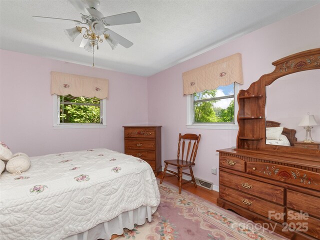 167 Panorama Dr, Franklin, NC 28734 - bedroom featuring light wood-style flooring and ceiling fan