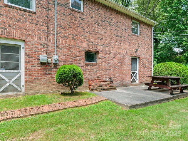 167 Panorama Dr, Franklin, NC 28734 - back of property featuring a patio area, a lawn, and brick siding