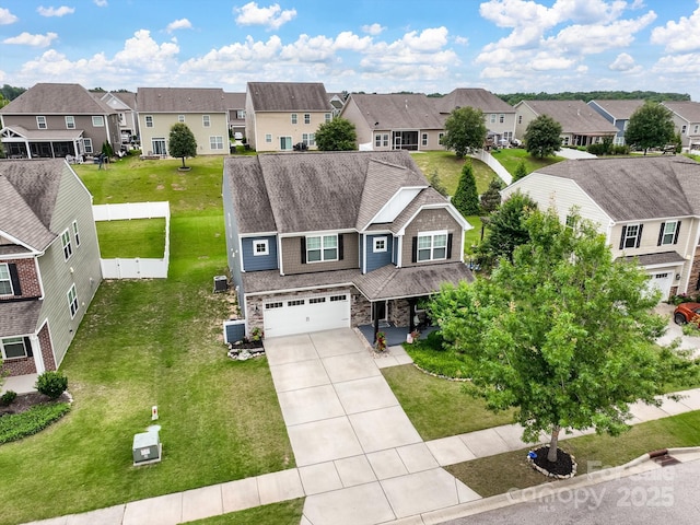 417 Livingston Dr, Lancaster, SC 29720 - view of front of home featuring a residential view, a garage, concrete driveway, and stone siding