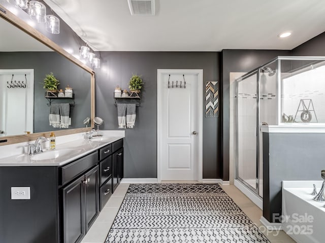 417 Livingston Dr, Lancaster, SC 29720 - full bath with double vanity, a garden tub, a shower stall, and tile patterned floors